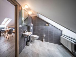 a bathroom with a sink and a toilet and a staircase at Studio V Šachu-4 by Interhome in Dačice