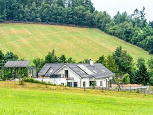 a house with solar panels on it in a field at Studio V Šachu-4 by Interhome in Dačice +29 photos