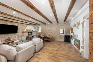 a living room with a couch and a table at Authentic Dalmatian Stone House-Kameni dvori in Selca kod Bogomolja
