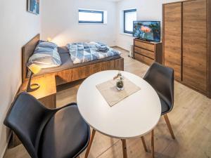 a room with a table and chairs and a bed at Studio V Šachu-2 by Interhome in Dačice