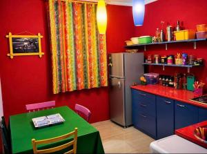 a kitchen with a green table and a refrigerator at Sea & Sun Grigoleti in Grigoleti