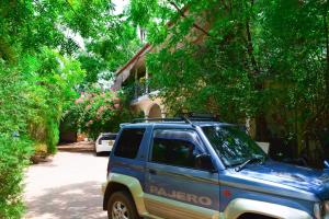 a blue truck parked in front of a house at Trinco Eddi Resort in Trincomalee