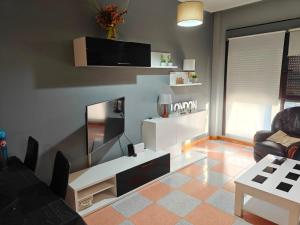 a living room with a flat screen tv on a wall at Apartamento cerca de Haro in San Vicente de la Sonsierra