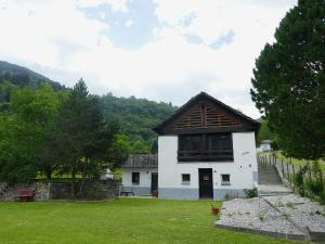 a small white building with a brown roof at Apartment Rina by Interhome in Olivone