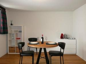 a dining room table with chairs and wine glasses at Apartment Rina by Interhome in Olivone