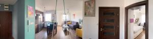 a room with a living room with a couch and a bedroom at Cora Lego Apartment City View near Stadium & Sinfonia Varsovia Optional Parking in Warsaw