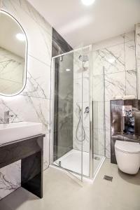 a bathroom with a shower and a toilet and a sink at Cichowiański Folk & Prestige in Poronin +235 photos