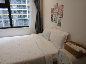 a white bed in a room with a window at Marina vinhomes in Long Bình +36 photos