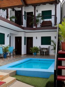 a villa with a swimming pool in front of a house at Hotel Valeria in Granada