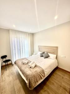 a bedroom with a large bed with two pillows on it at Apartamento La Muralla 2B in Aguilar de Campóo +2 photos