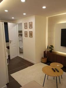 a living room with a table and a television at Apartman Kvesić in Široki Brijeg