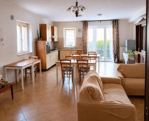 a kitchen and living room with a couch and a table at Villa Andrea B&B in San Silvestro
