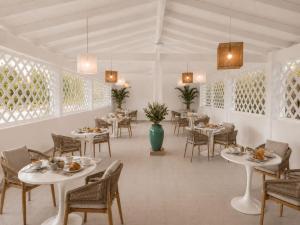 a dining room with tables and chairs and lights at Hotel Cala d'Oro - Hotel a pochi minuti dal mare di Cala Liberotto in Cala Liberotto +11 photos
