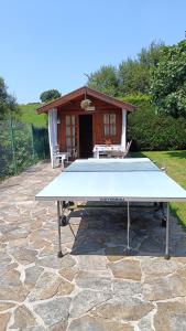 a ping pong table in front of a house at Posada Herrán in Santillana del Mar