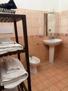 a bathroom with a sink and a toilet and a mirror at Villa Andrea B&B in San Silvestro +7 photos