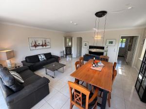 a living room with a couch and a wooden table at Syltstyle 12 in Tinnum +9 photos
