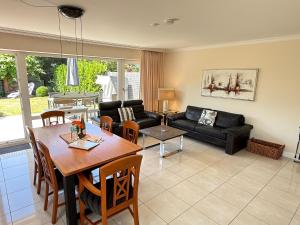 a living room with a table and a couch at Syltstyle 12 in Tinnum
