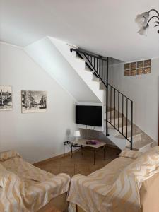 a living room with two beds and a tv at Villa Andrea B&B in San Silvestro