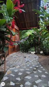 an outside area of a building with plants and flowers at Casa kumake tayrona in El Zaino