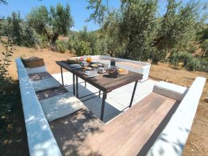 a picnic table with two benches and food on it at Alegria rustica 2 in Mação +6 photos