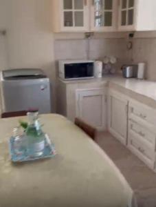 a kitchen with a bottle of water on a table at Shivram guest house in Plaine Magnien