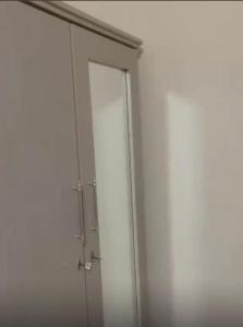 a white cabinet with a door in a room at Shivram guest house in Plaine Magnien
