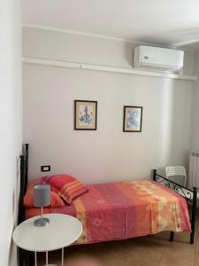 a bedroom with a bed and a white table at Villa Andrea B&B in San Silvestro