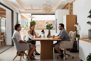 a group of three people sitting around a table at Axopetra Boutique Hotel in Agiassos +79 photos