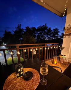 a table with a glass of wine on a deck at Marena Studio - Santa Marina, Sozopol in Sozopol