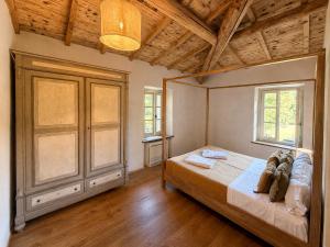 a bedroom with a bed and two windows at Tenuta Seriole in Poppi