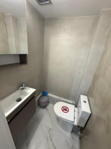 a bathroom with a white toilet and a sink at EVE's house 6 - Corinth center loft in Korinthos +4 photos