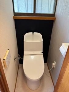 a bathroom with a white toilet in a room at 海っぺりー作田 in Katakai +7 photos