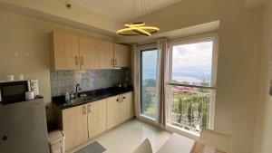 a kitchen with a large window with a view at Casa Lumière in Tagaytay
