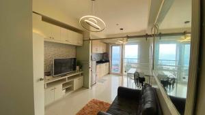 a living room with a couch and a television at Casa Lumière in Tagaytay
