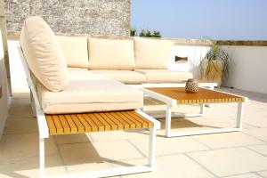 a white couch and a coffee table on a patio at Antica Stella in Specchia