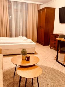 a hotel room with a bed and a coffee table at Marena Studio - Santa Marina, Sozopol in Sozopol +51 photos