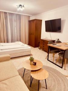a living room with a bed and a couch and a table at Marena Studio - Santa Marina, Sozopol in Sozopol