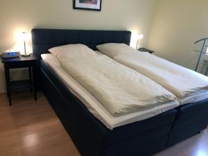 a bed with two white pillows on top of it at Ferienhaus Stausee Bitburg in Biersdorf am See