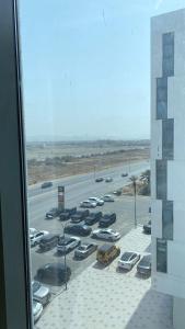 a view of a parking lot with cars parked at Premium 2BHK Modern Design in Muscat