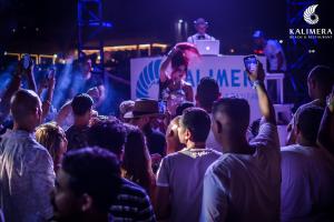 a crowd of people standing in a crowd with a woman on a stage at Naama Lofts in Sharm El Sheikh