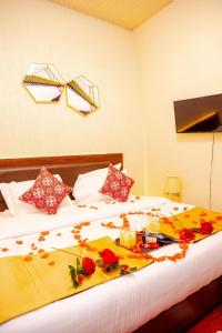 a bedroom with a bed with flowers on it at Lemon hills hotel in Runda +24 photos