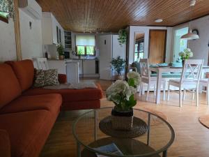 a living room with a couch and a table at Smaland Trollsjö in Mönsterås
