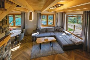 a living room with a couch and a table at Kamienny Horyzont in Bereżnica Wyżna