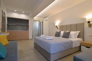 a bedroom with a large bed with towels on it at Olympus Diamond studios in Olympic Beach +51 photos