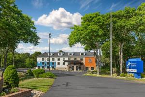 a building on a street with trees and a road at Holiday Inn Express Hyannis - Cape Cod by IHG in Hyannis