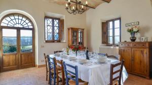 a dining room with a white table and chairs at ALBORATA 10, Emma Villas in San Giovanni dʼAsso