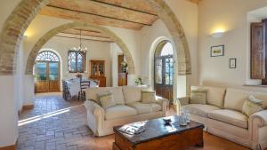 a living room with two couches and a table at ALBORATA 10, Emma Villas in San Giovanni dʼAsso