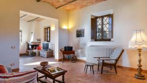 a living room with a couch and a table at ALBORATA 10, Emma Villas in San Giovanni dʼAsso +40 photos