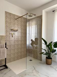 a shower with a glass door in a bathroom at Cortijo Cenascuras in Priego de Córdoba +32 photos