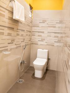 a bathroom with a toilet and a shower at Hotel Asha Palace By Basotel in Deoghar +12 photos